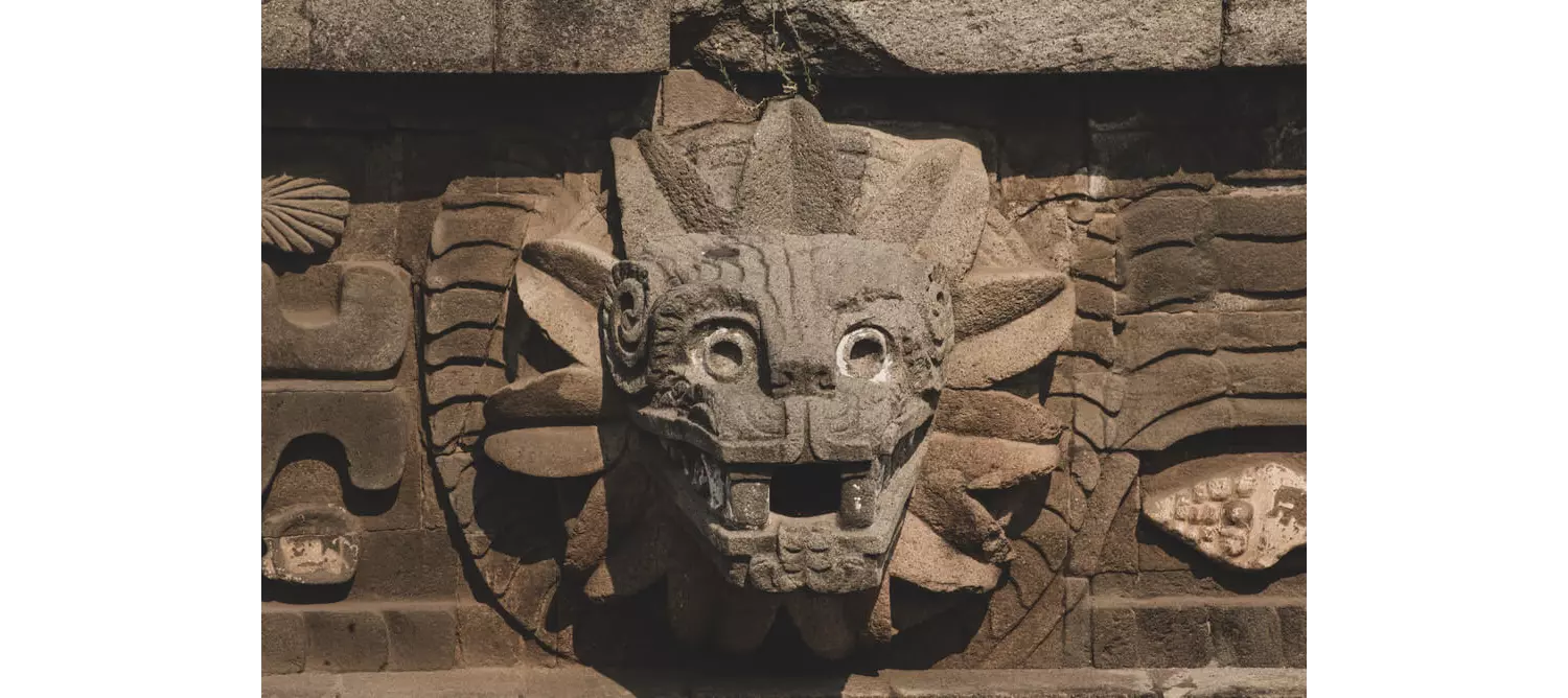 Kukulcan Boulevard: A stone carving of the Kukulcan Mayan God