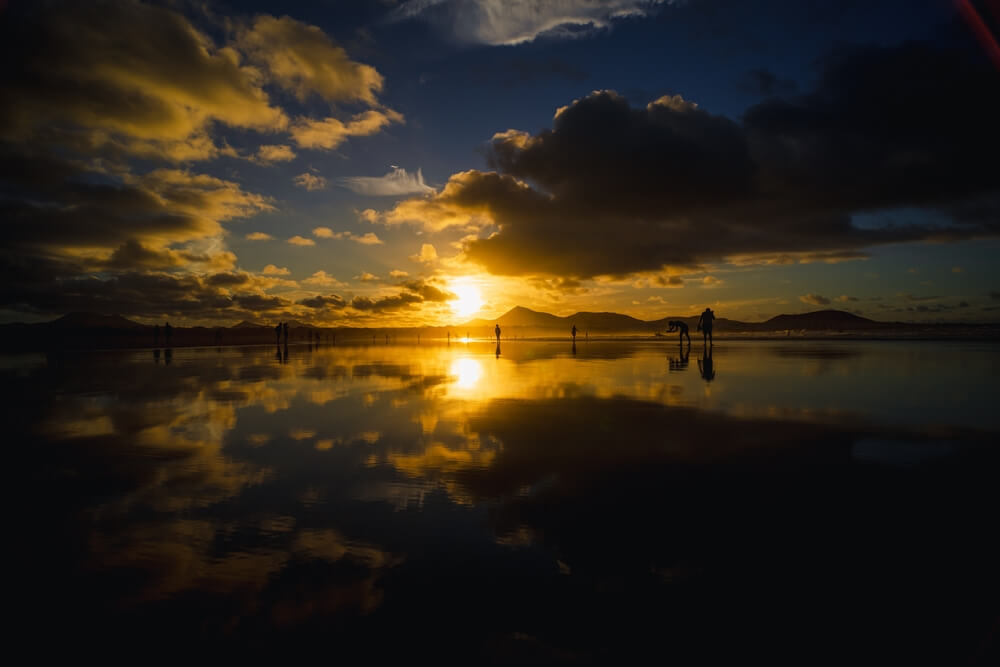 Playa Famara: Sun setting over Playa Famara with Lanzarote’s volcanoes in the background