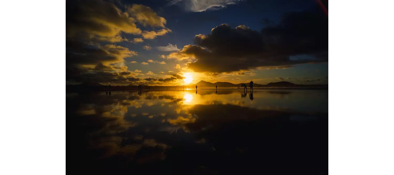 Playa Famara: Sun setting over Playa Famara with Lanzarote’s volcanoes in the background