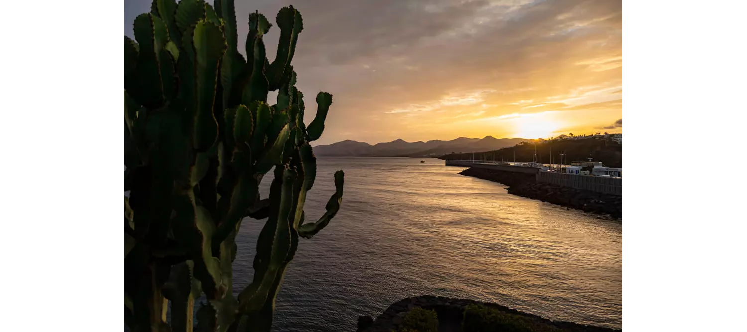 Lanzarote nightlife: Sun setting over the port of Lanzarote with boats in the harbour