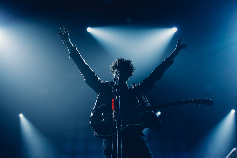 Live music in Madrid: Man performing on stage with a guitar