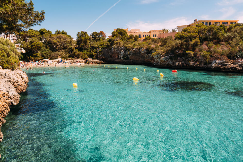Cala Ferrera: A turquoise cove surrounded by golden cliffs and trees