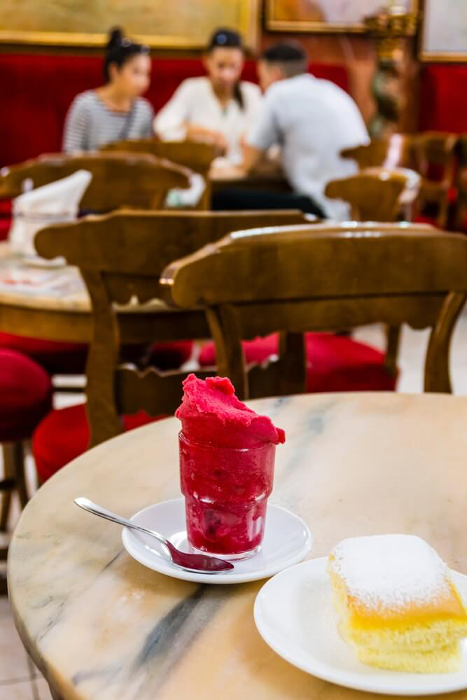 Mallorca family holidays: A cafe table with ice cream in a glass and a pastry