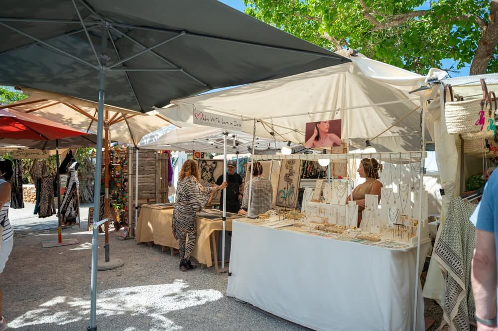 Markets in Ibiza: People dressed in white shopping at the stalls at Las Dalias market