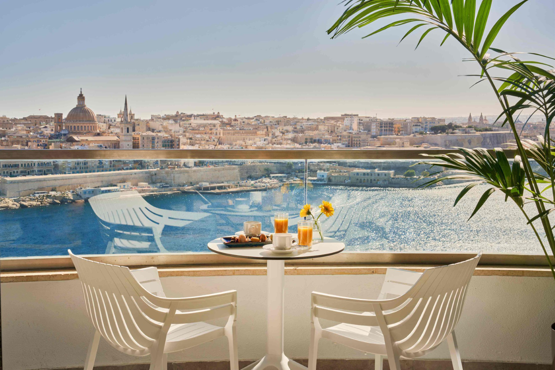 Mediterranean cuisine: A table and two chairs on a hotel balcony with food