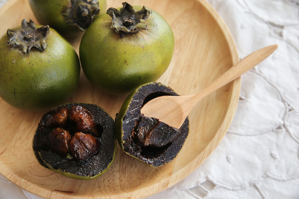 Black sapote fruit has a dark, custard-like interior that tastes like chocolate.