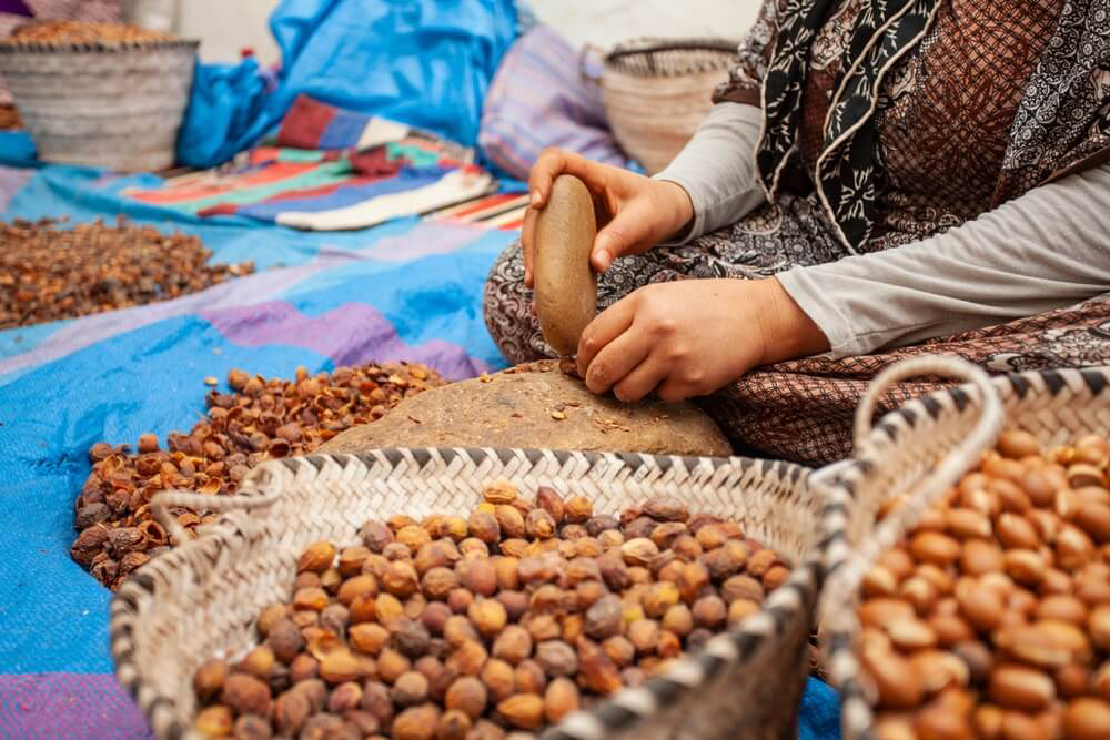 Moroccan beauty products: Moroccan lady making argan oil in the traditional way