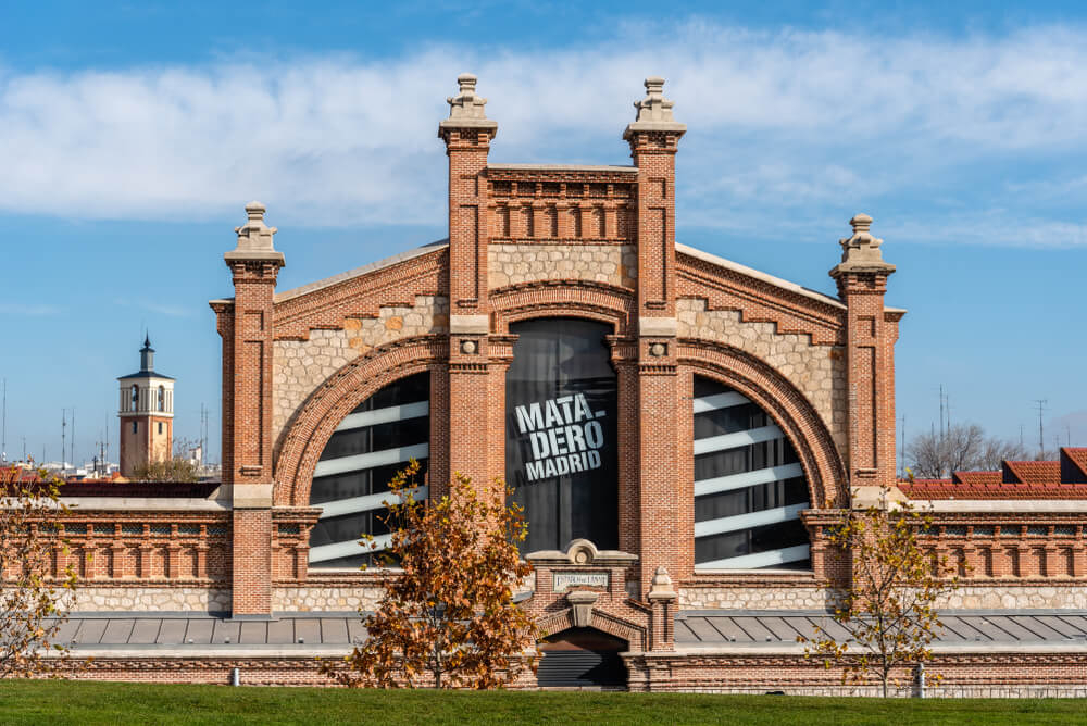 Matadero: Old, red brick arched building with Matadero Madrid logo on windows