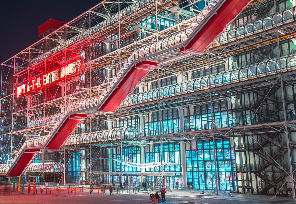 Centre Pompidou: The glass facade of the Centre Pompidou lit up at night
