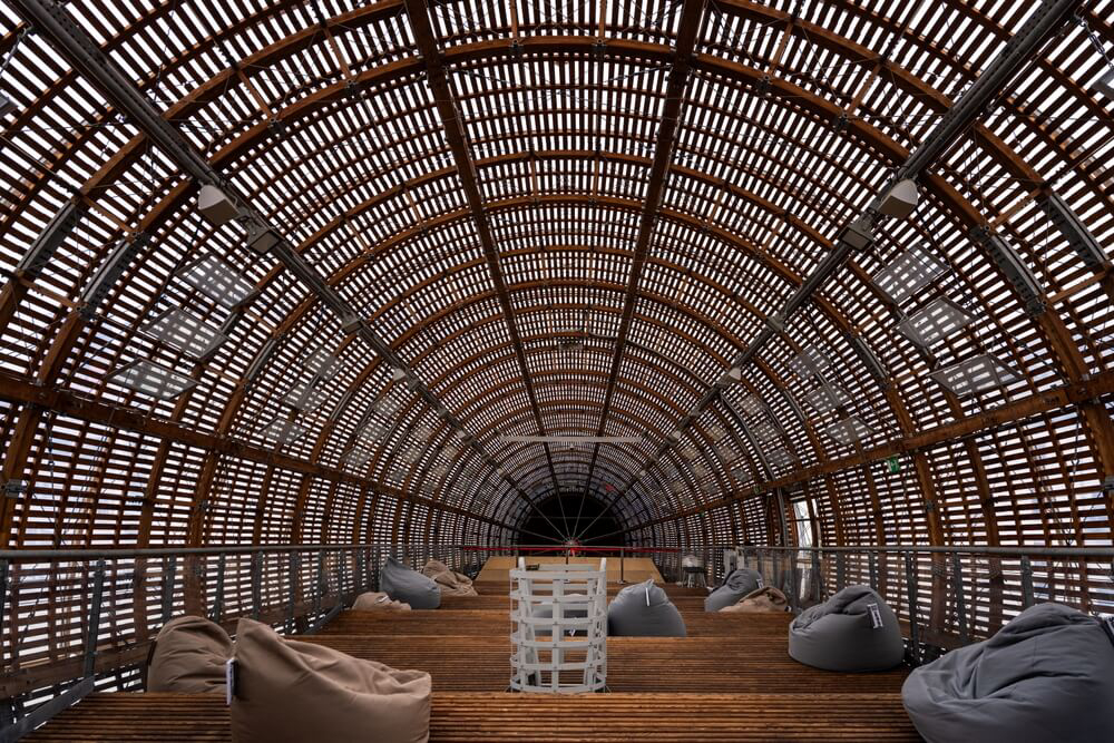 DOX: A curved wooden roof with a wooden floor and bean bags