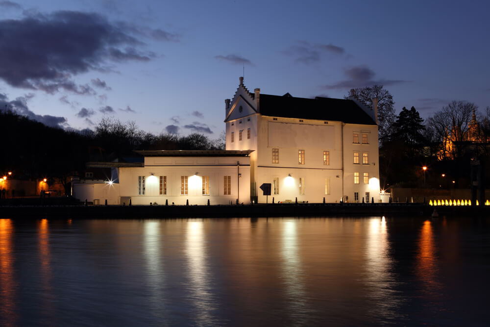 Museum Kampa: A tall white building with black roof next to the river