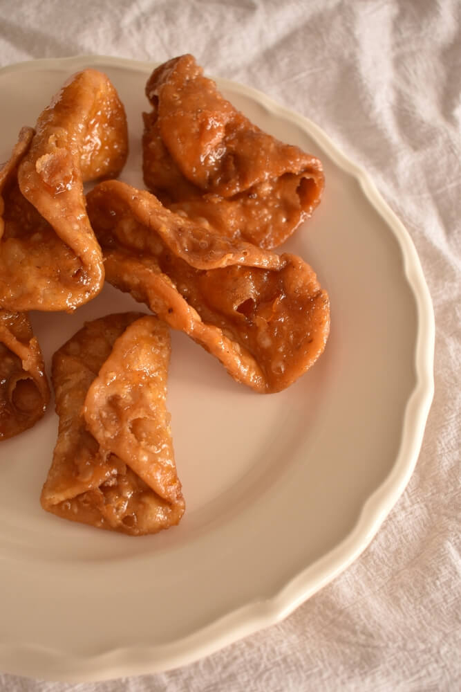 Pestiños: Fried pastry on a plate in individual curls