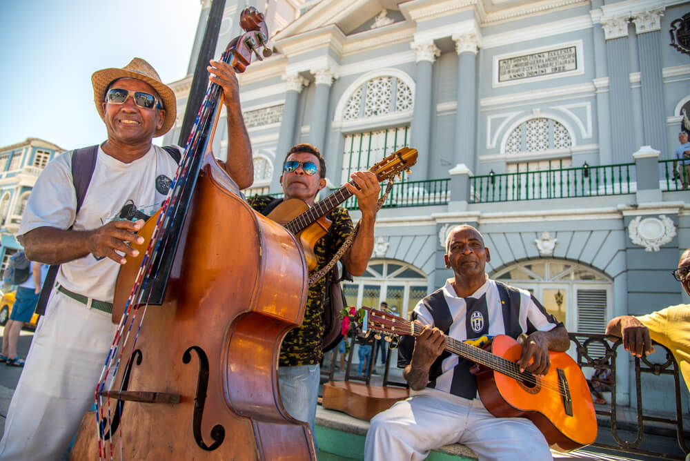 Santiago de Cuba: A group of men playing musical instruments in the street