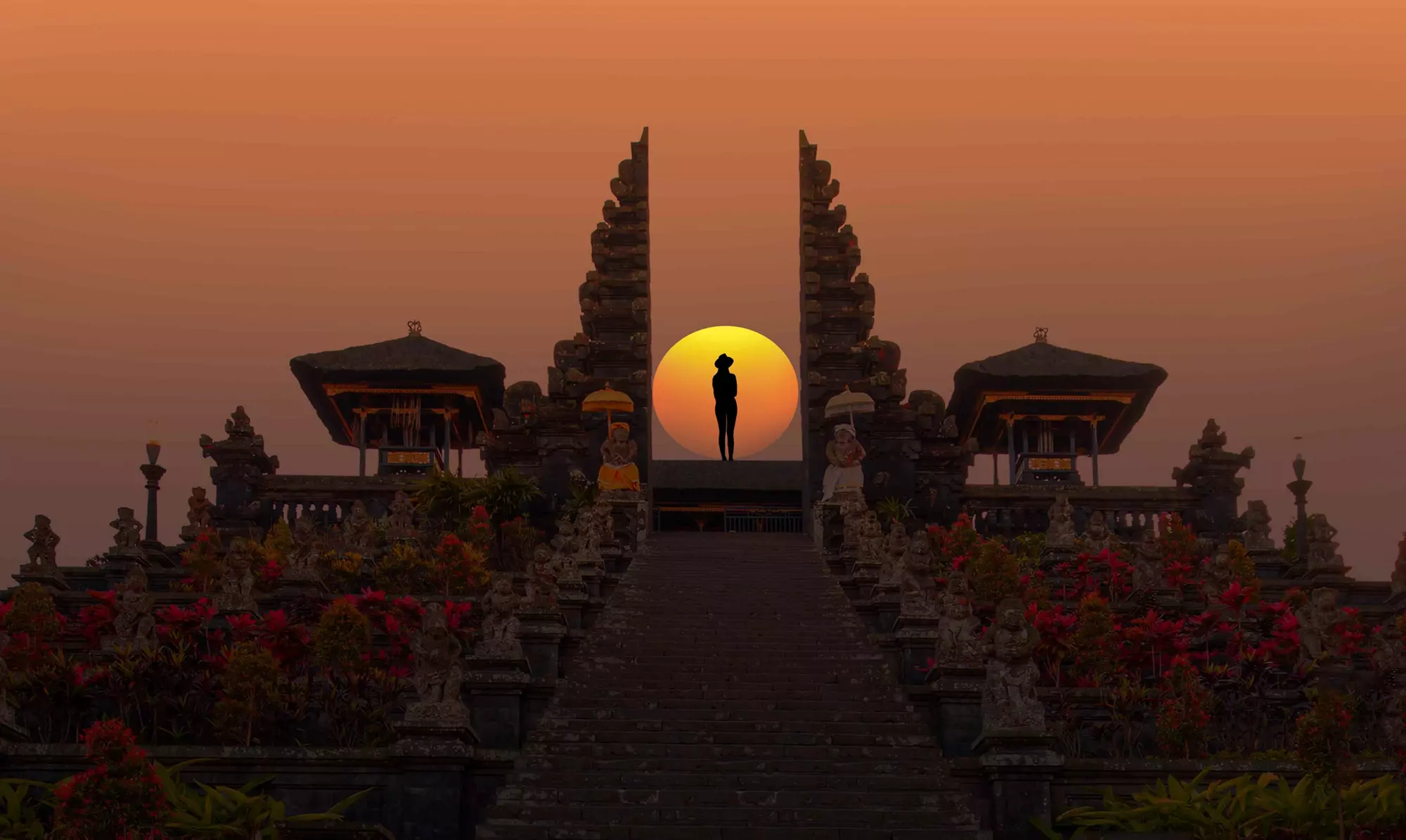 Places to visit in Indonesia: Sunset at a temple with a person standing in front of the sun