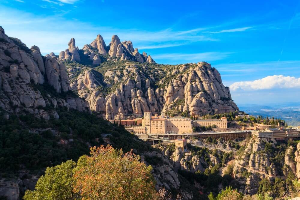 Places to visit near Barcelona: a panoramic view of Montserrat Monastery amid crags and towers