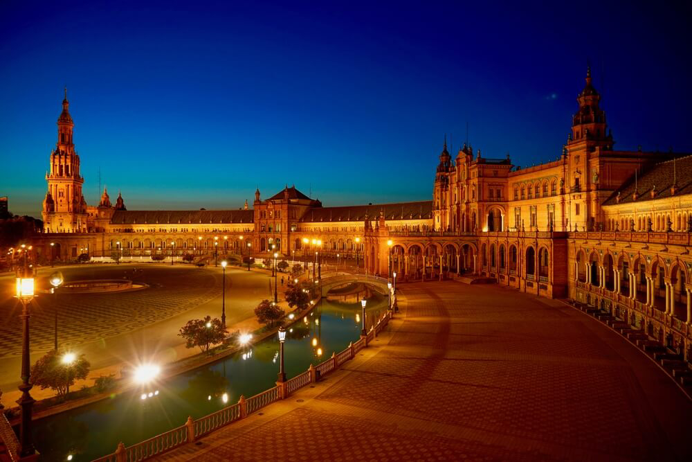 Plaza de España: A view of Seville’s Plaza de España building lit up at night