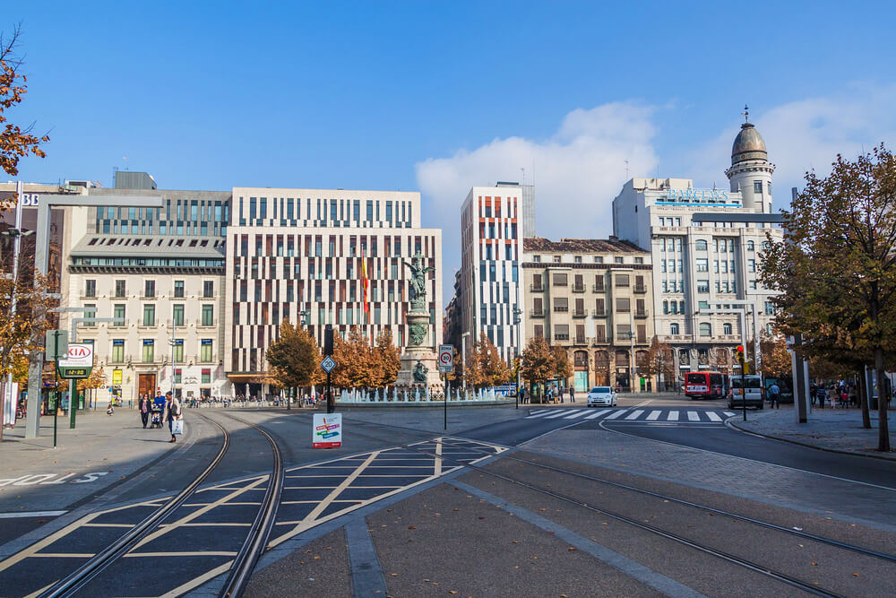 Spanish Square Zaragoza: A city street with tram lines and buildings in the background