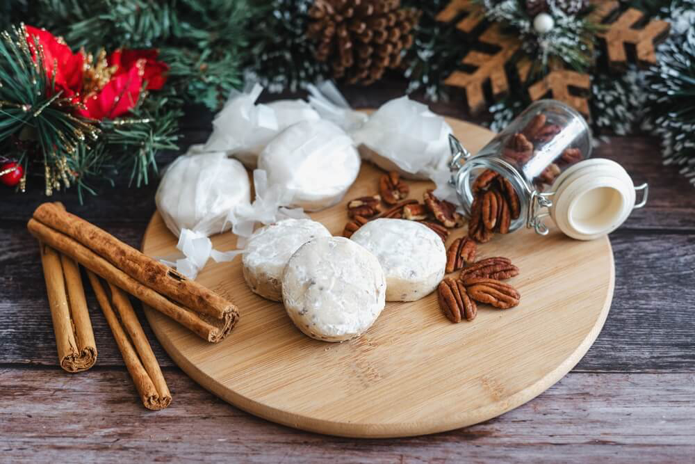 Mantecados: Round shortbread biscuits piled onto a wooden tray