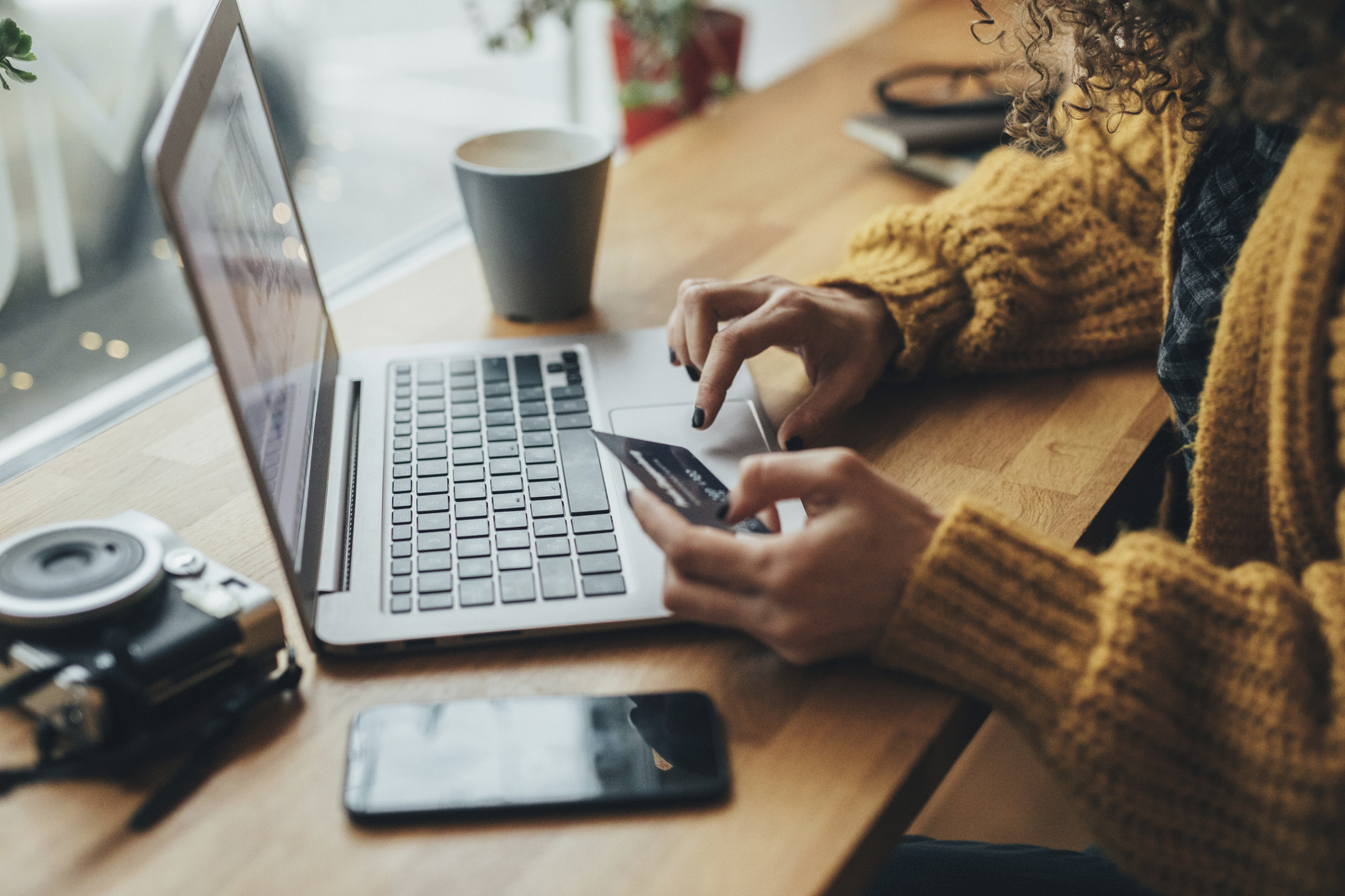 Woman in cafe shopping online with laptop