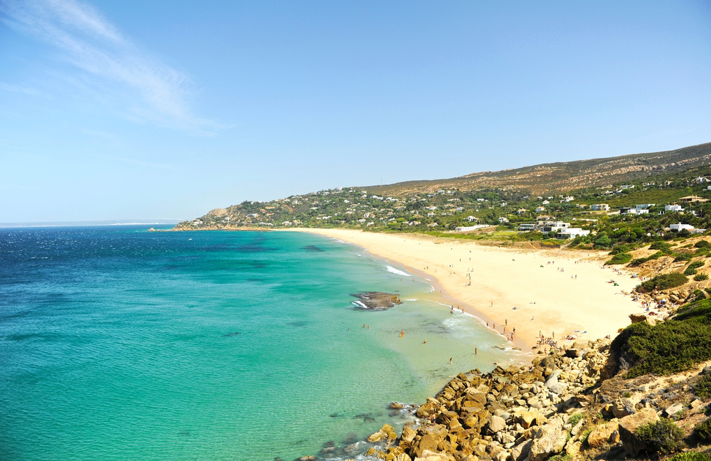 Province of Cadiz: A golden sand beach with turquoise water and rocky landscape