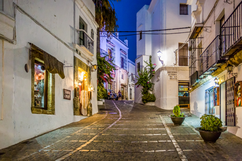 Province of Cadiz: Cobbled street and white-washed buildings of Vejer de la Frontera at night