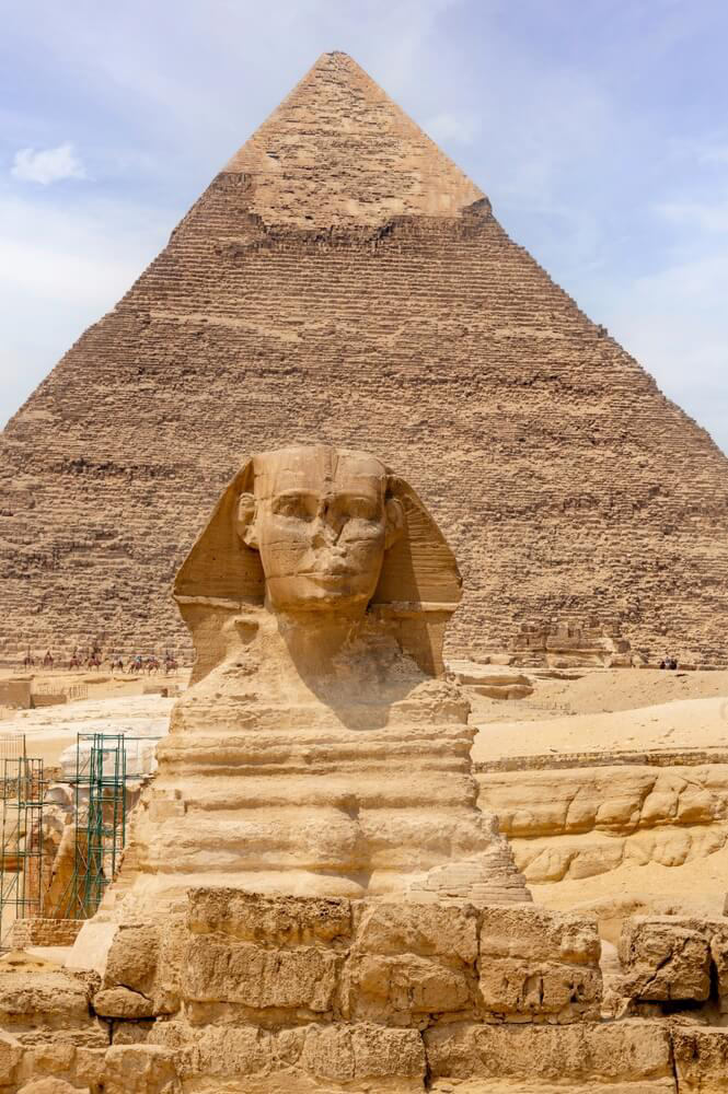 Sphinx: A close-up of the sphinx statue alongside an imposing stone pyramid