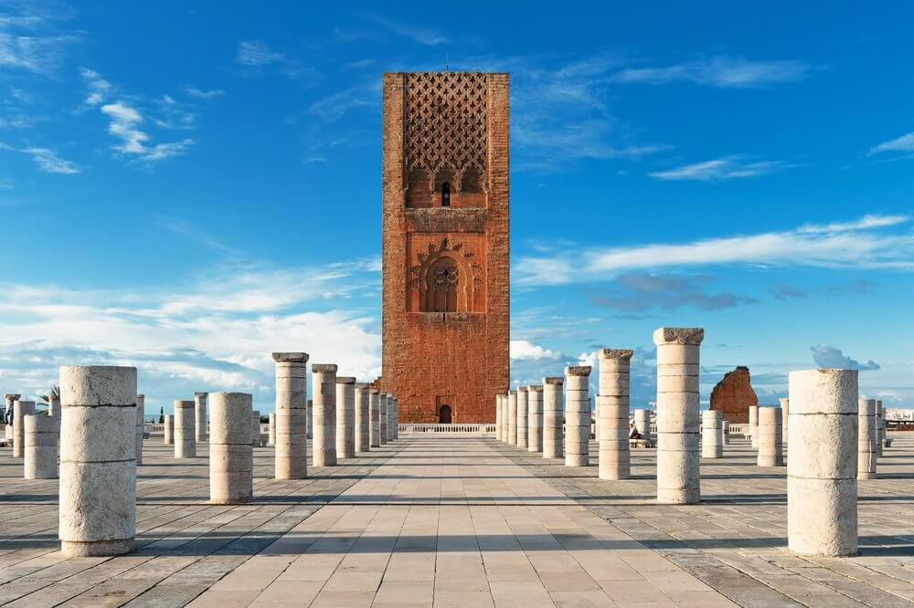 Tower of Hassan: Red brick tower in a white square surrounded by white stone pillars