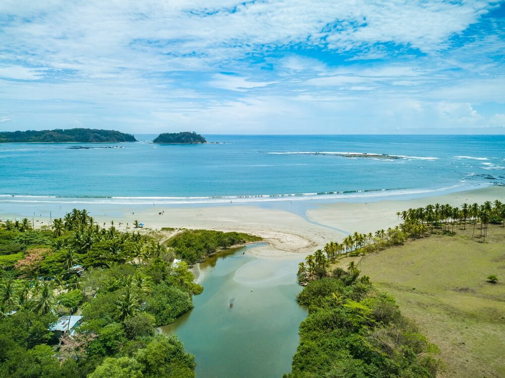 Samara Beach, Guanacaste: White sand beach with green grassy area in Guanacaste Costa Rica