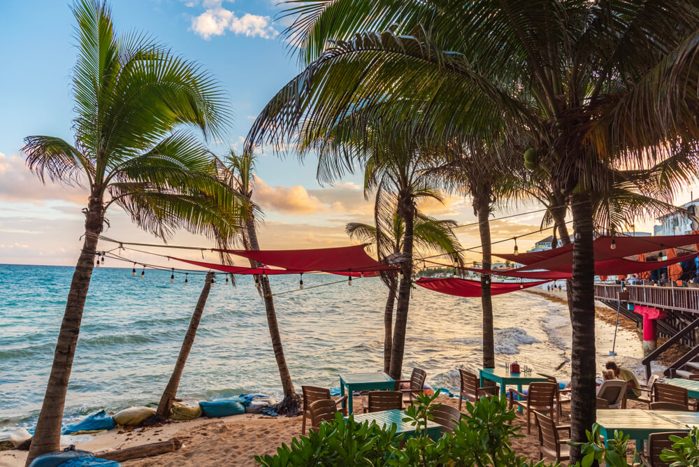 Start your Playa del Carmen nightlife adventure with a drink at a beach bar