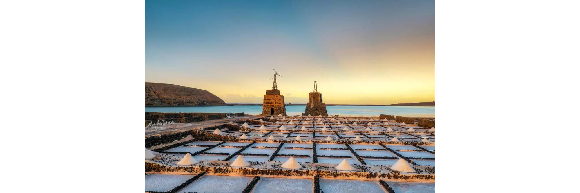 Salinas del Janubio: Sun setting over the salt flats with the sea in the background