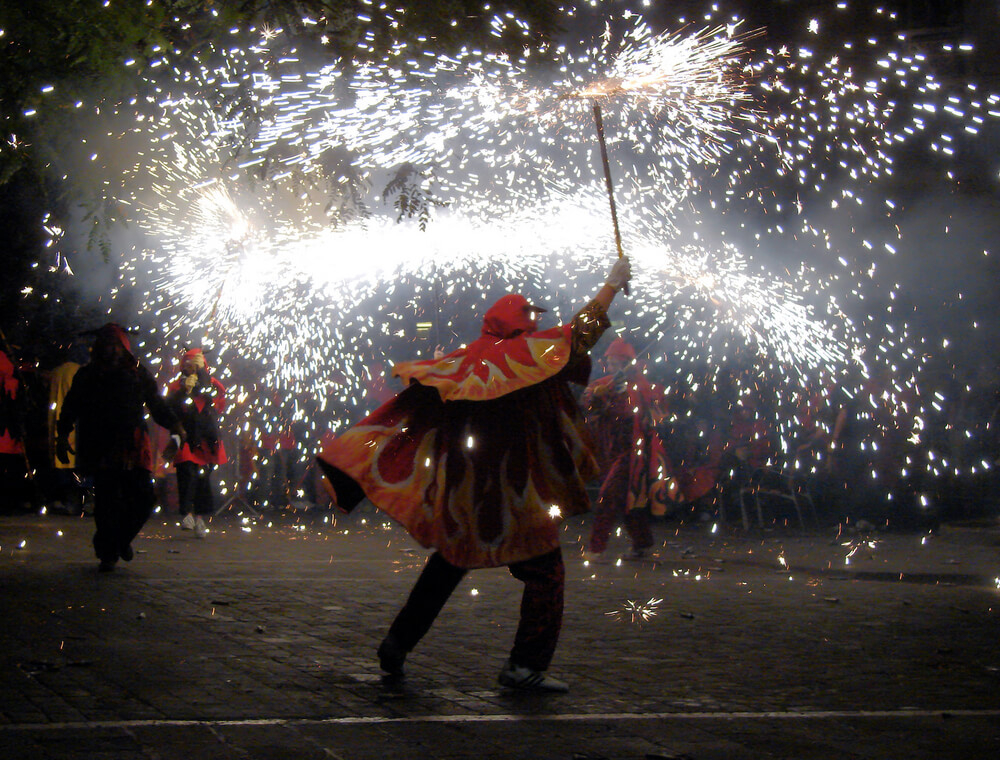 San Juan Festival: Men dancing in capes with fireworks