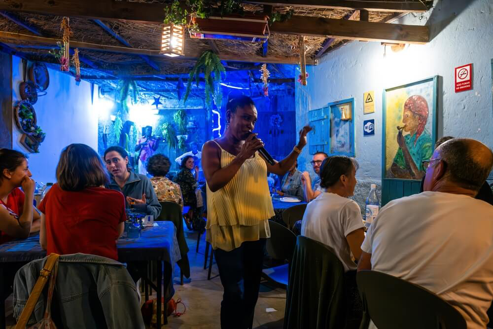 Santiago, Cape Verde: A traditional Cape Verde singer in a restaurant at night