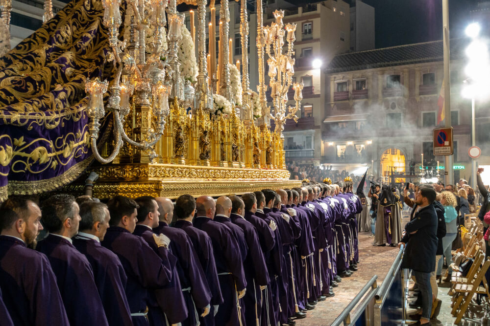 Semana Santa: Robed men carrying a large religious processional altar 