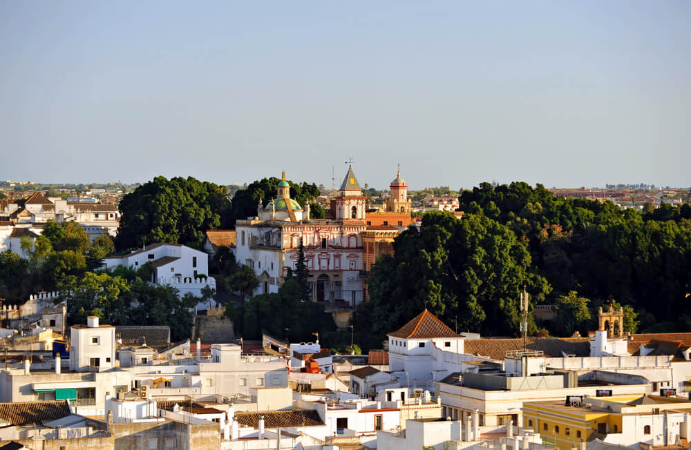 Sanlúcar de Barrameda: An ornate church surrounded by trees and white houses