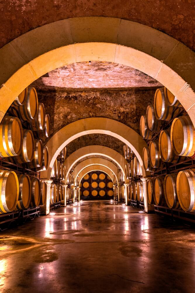 Sherry: A hall of barrels inside a winery bathed in a golden glow
