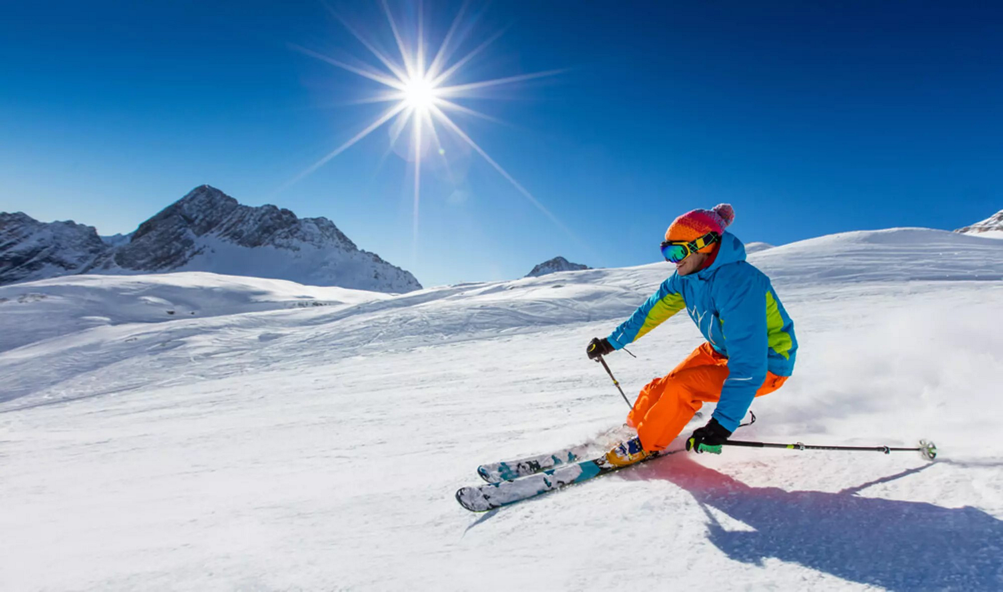 Skiing in Spain: A man skiing down the mountain in the sunshine