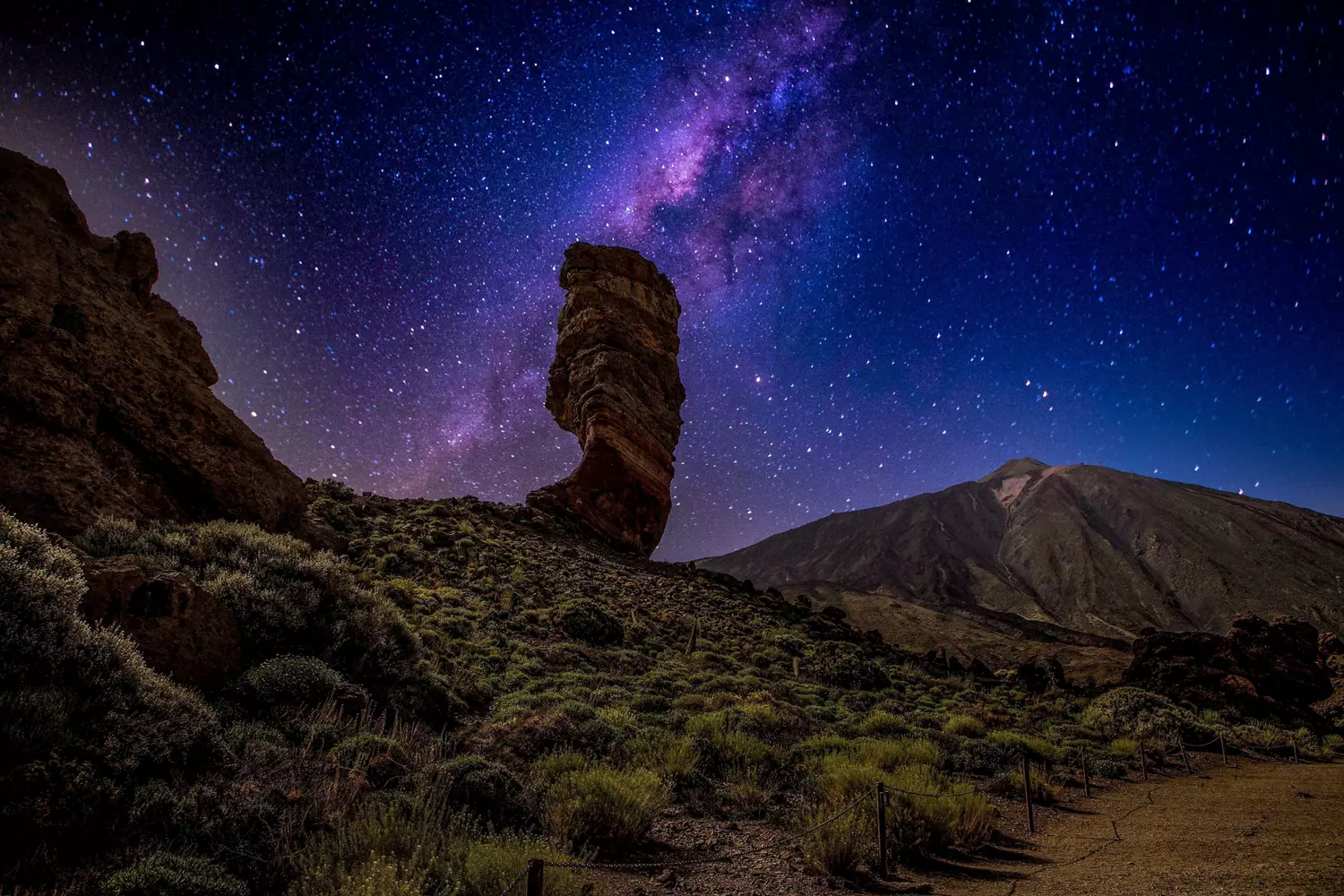 Stargazing in Tenerife: A volcanic skyline of El Teide National Park with a purple starry sky