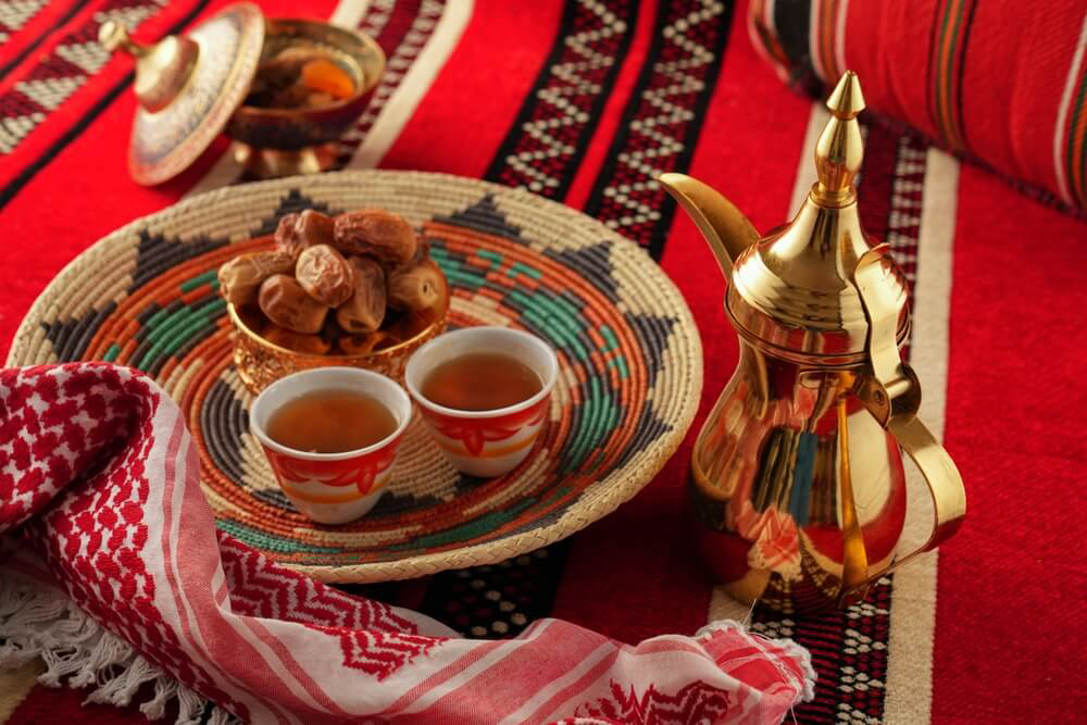 Dubai Coffee Museum: A table with a coffee pot and bowl of dates