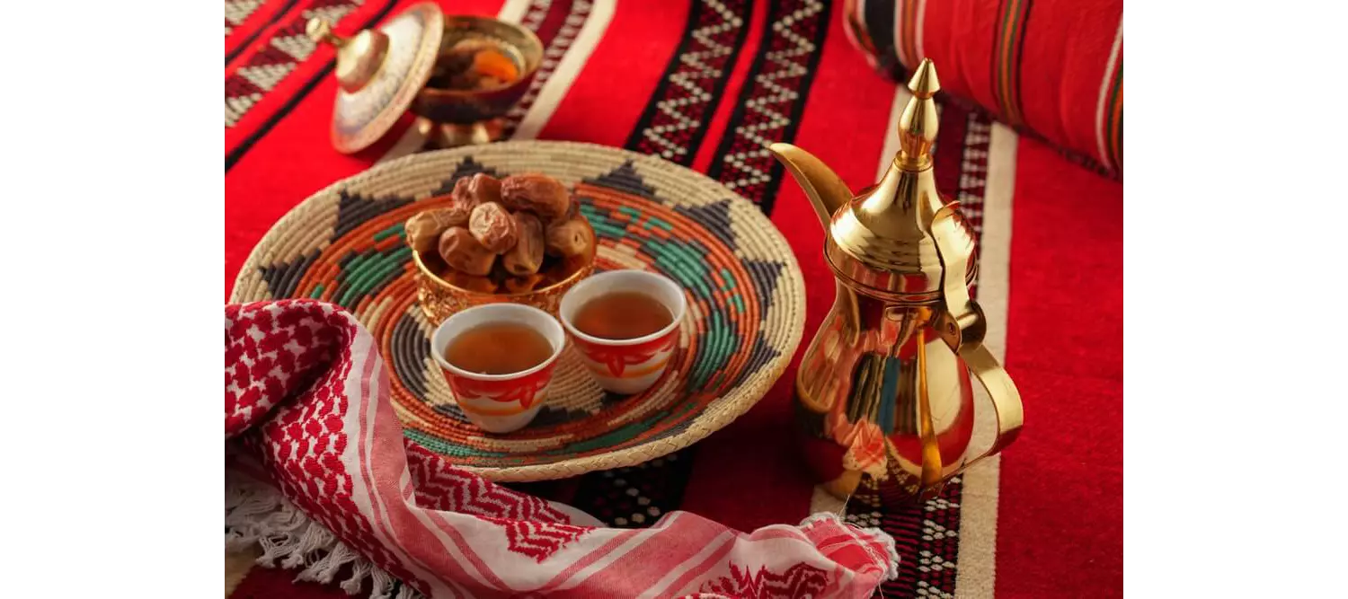 Dubai Coffee Museum: A table with a coffee pot and bowl of dates