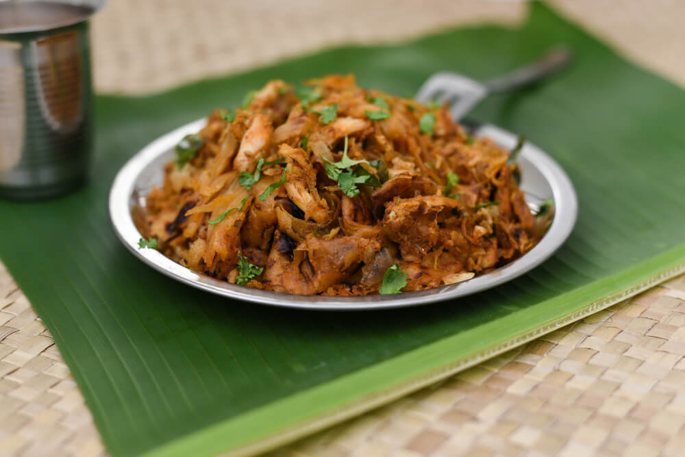 Sri Lankan dinner: A plate of Kothu Roti served on a silver plate placed on a banana leaf