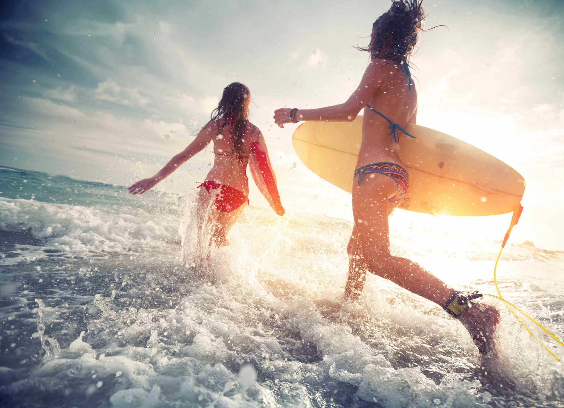 Surfing in Spain: Kids playing in the sea with surfboards 