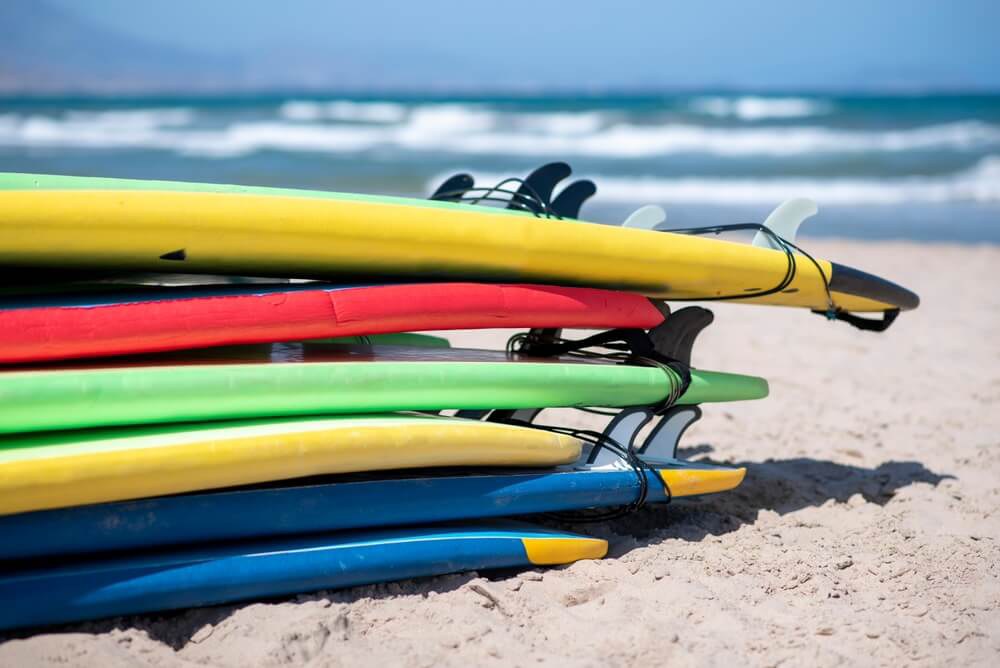 Surfing in Spain: A stack of surfboards on the beach