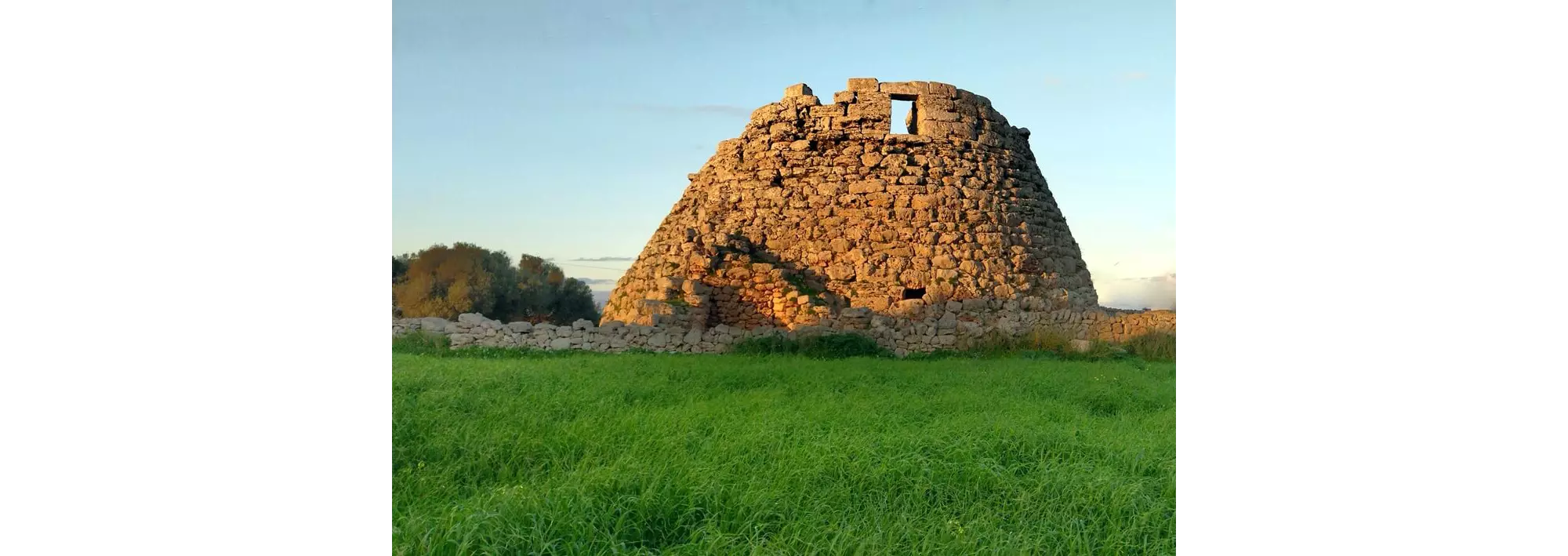 A stone megalith on a grᴀssy stretch of land