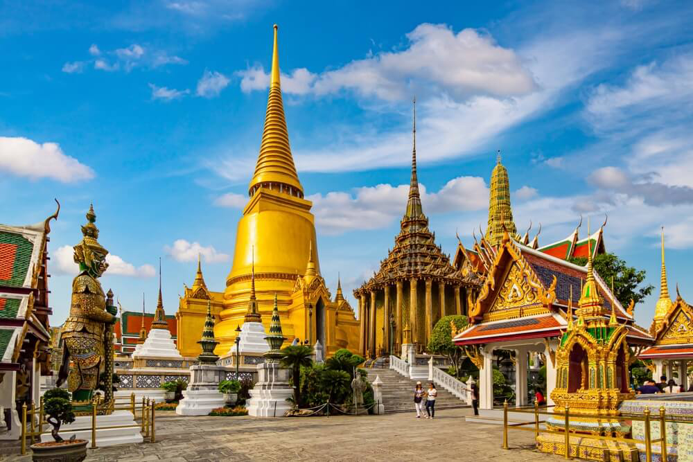 Wat Phra Kaew: A golden temple complex with green and red details