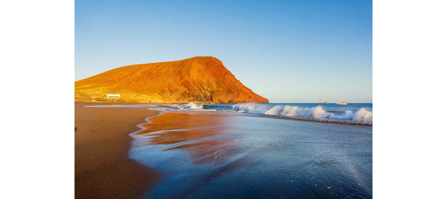 Teneriffa schönste Strände: Naturstrand mit goldbraunem Berg.