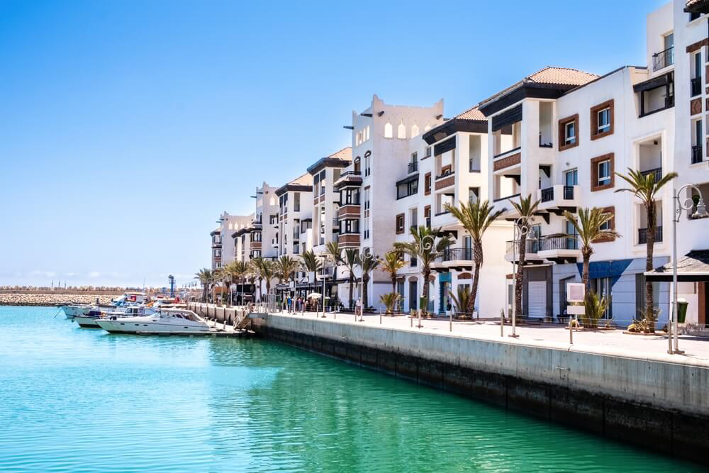 Things to do in Agadir: Turquoise water with yachts moored and white buildings