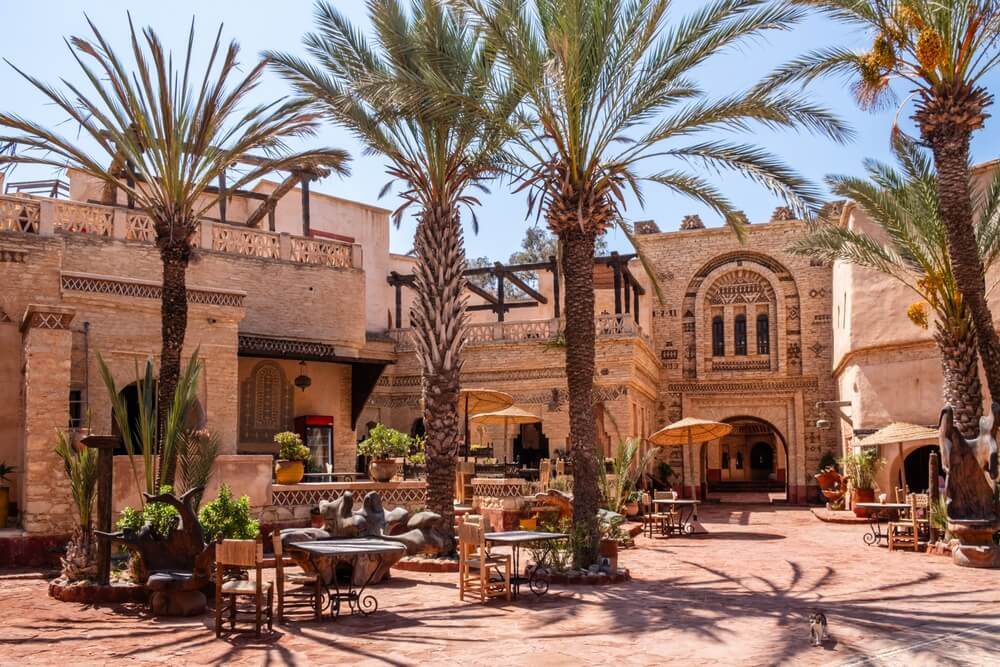 Medina: Honeyed stone ornate marketplace building with plants