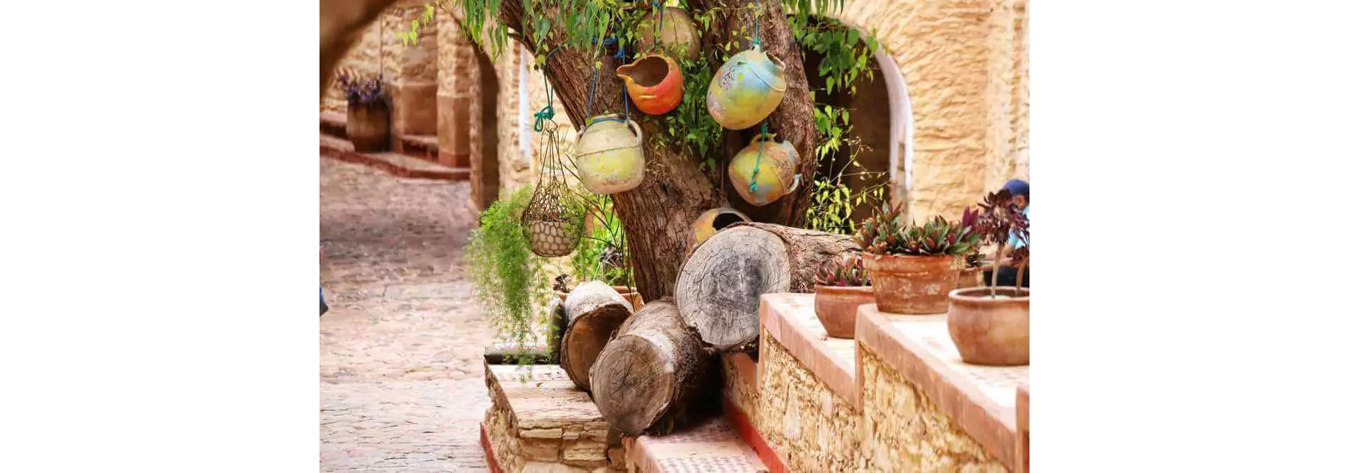 Things to do in Agadir: A traditional street with clay pots hanging from a tree