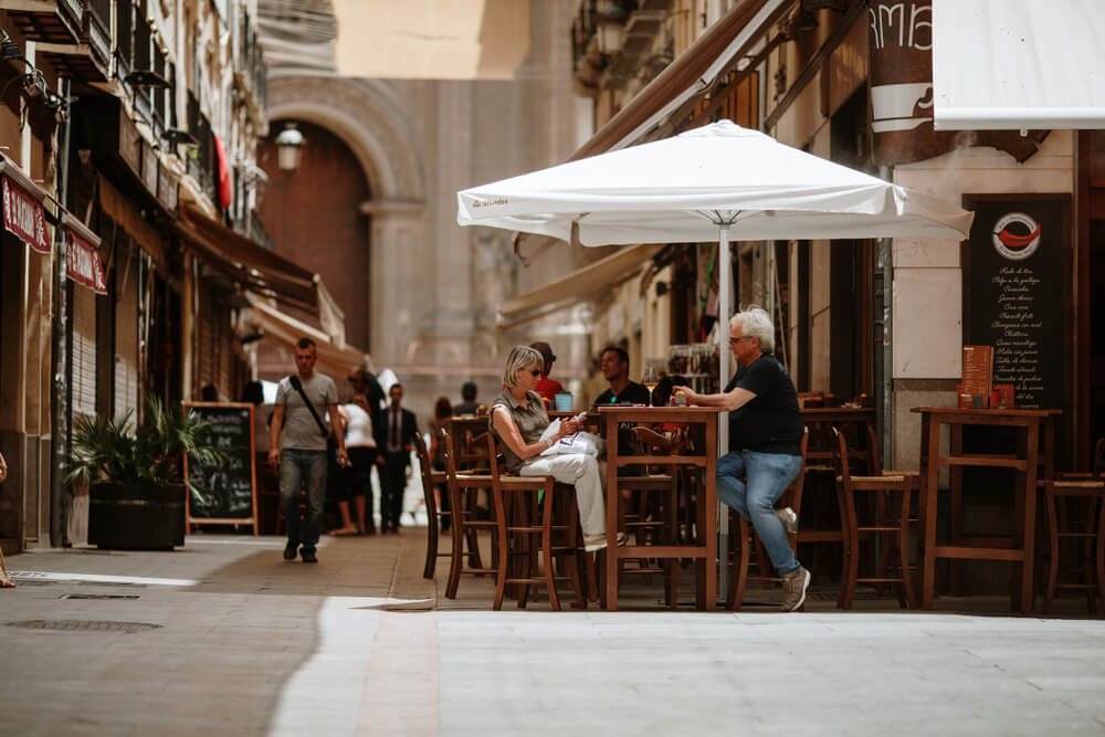 Tapas: A couple sitting outside a traditional bar in Granada