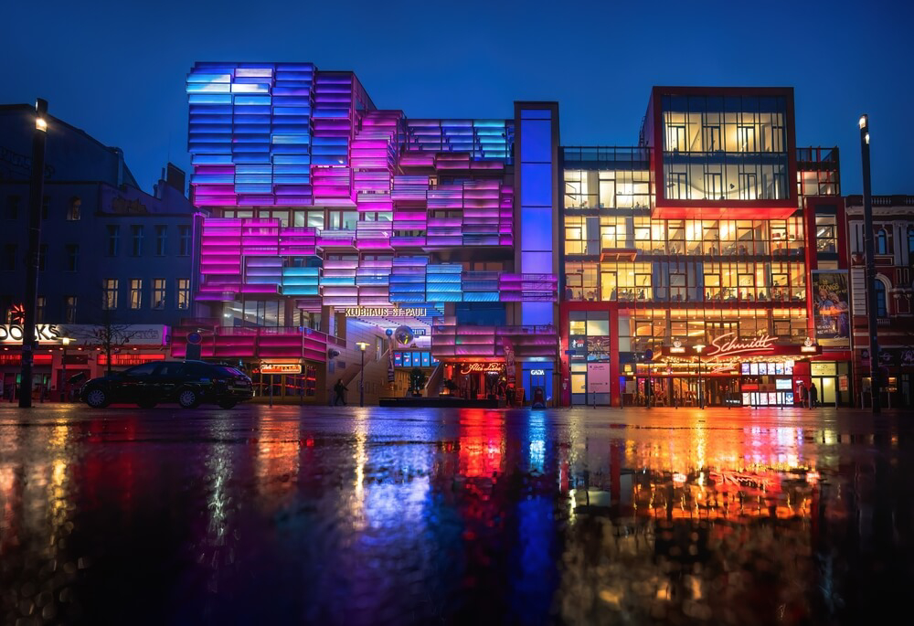 St. Pauli: Tall urban buildings lit up at night in the centre of Hamburg